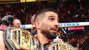 Ilia Topuria poses with UFC championship belts before UFC Freedom 250