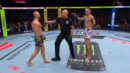 Max Holloway faces Conor McGregor as referee Marc Goddard steps between them at UFC 329