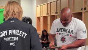 Paddy Pimblett and Daniel Cormier during UFC 329 fight week wager payoff