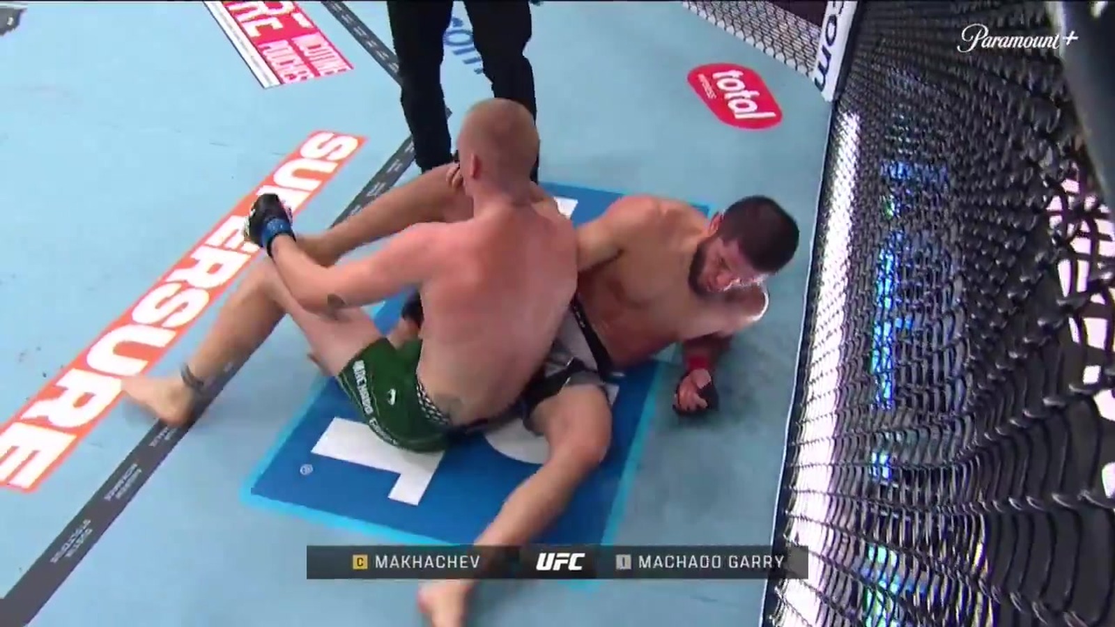 Islam Makhachev grapples Ian Machado Garry during their UFC 330 welterweight title fight.