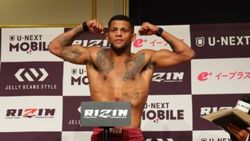 Patchy Mix poses on the scale after weighing 63.85 kilograms for RIZIN 54.