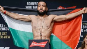 Belal Muhammad holding a Palestinian flag at an earlier UFC weigh-in