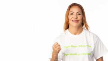 Cris Cyborg raises her fist during an October 2026 interview portrait