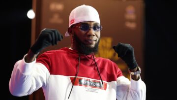 Carlos Adames poses with raised fists during a public workout appearance