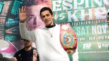 Rafael Espinoza poses with his WBO featherweight championship belt