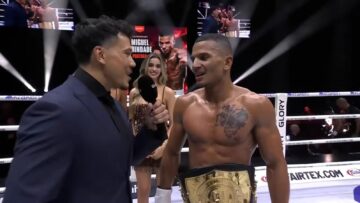 Miguel Trindade wearing the GLORY featherweight belt after defeating Deniz Demirkapu at GLORY 110