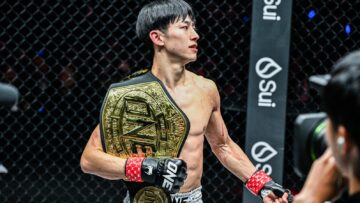 Nadaka Yoshinari holding his ONE atomweight Muay Thai championship belt after ONE SAMURAI 4