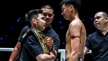 Prajanchai and Aliff face off in the ring with their ONE championship belts.